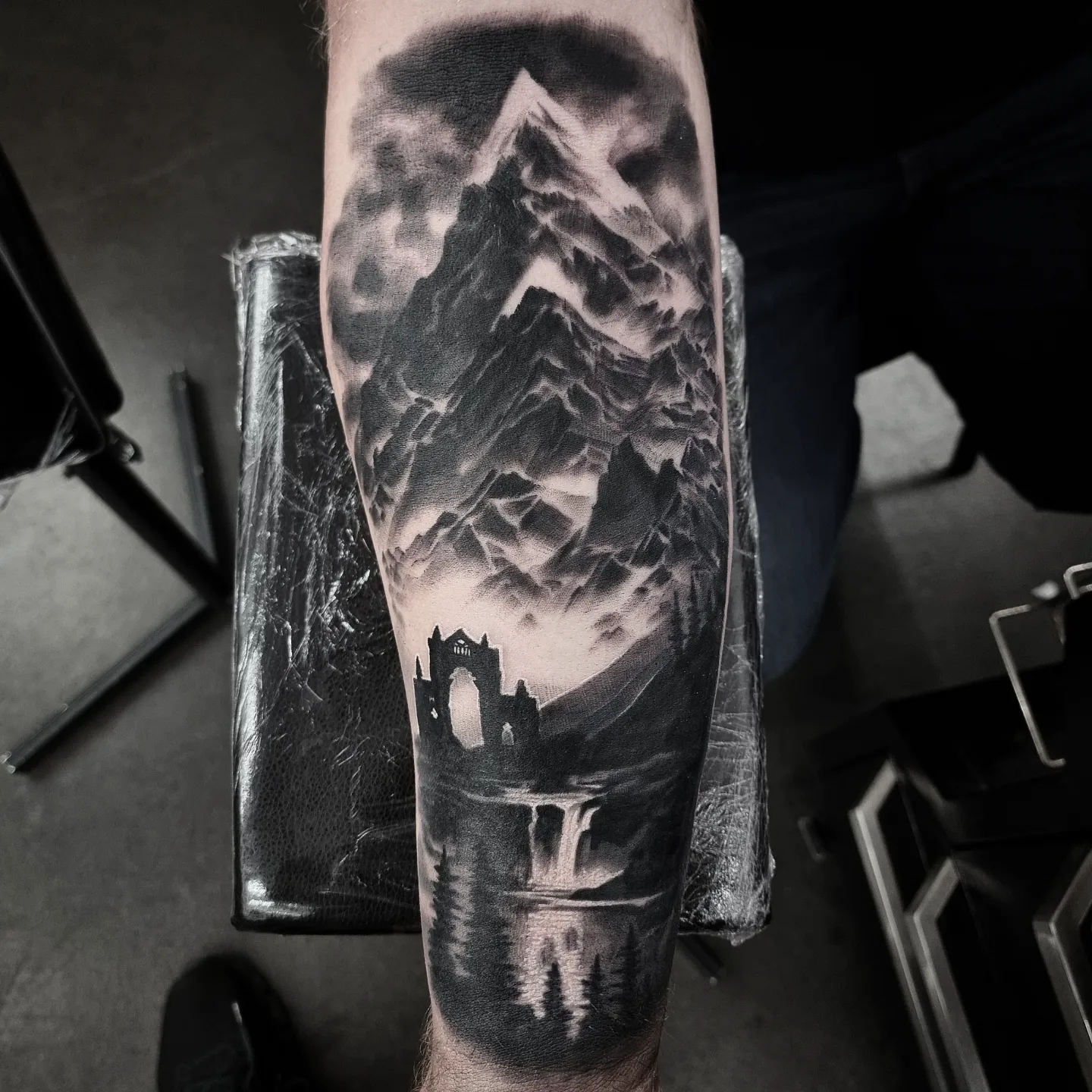 Photorealistic black and grey scenery tattoo by Tomek Turlej, Studio XIII Gallery, Scotland