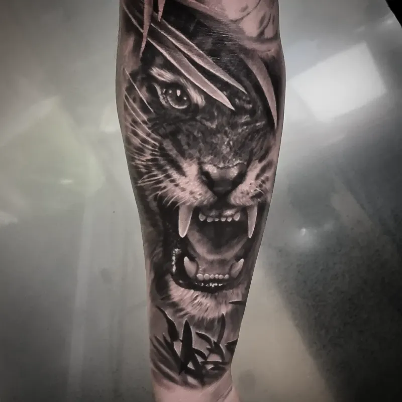 Realistic black and grey wildlife tattoo by Tomek Turlej at Studio XIII Gallery Edinburgh