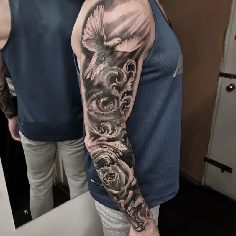 Large scale black and grey sleeve tattoo by Tomek Turlej, Studio XIII Gallery, Scotland